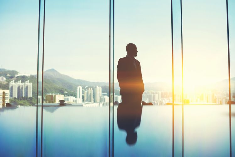 silhouette of businessman in front of cityscape silhouette of businessman in front of cityscape